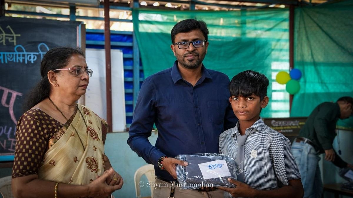 A student receives his new uniform