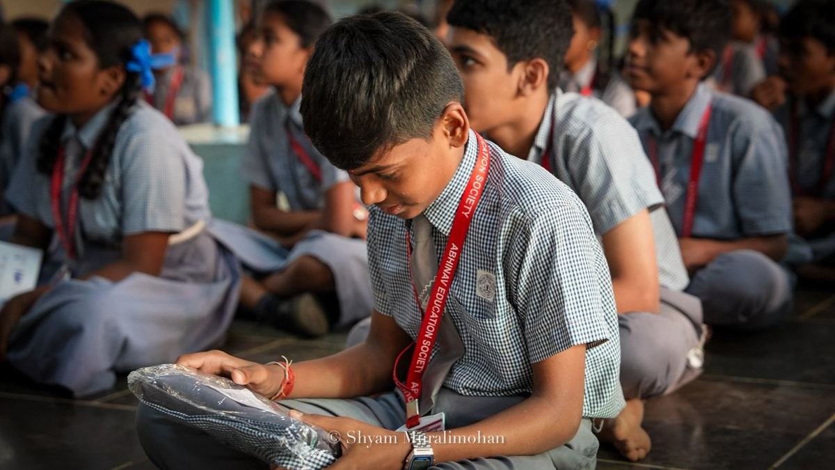 A student opens his new uniform