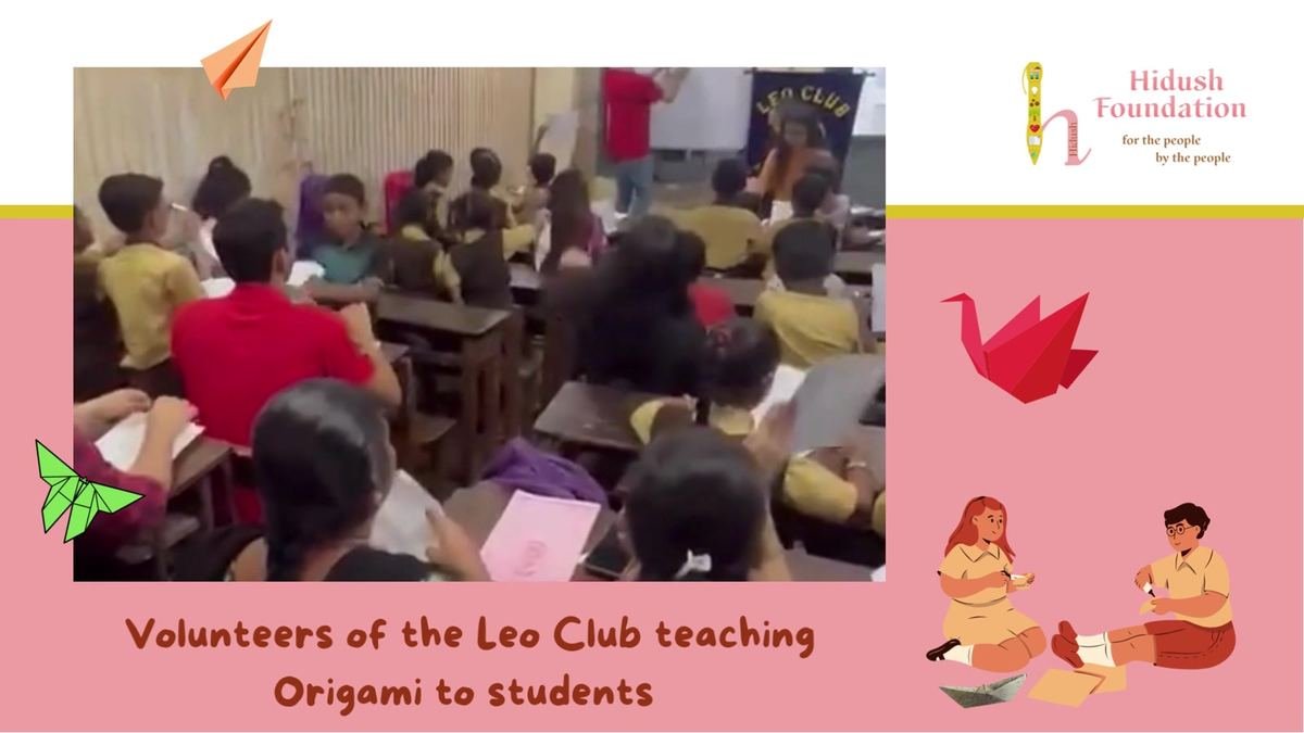 Leo Club volunteers teaching origami
