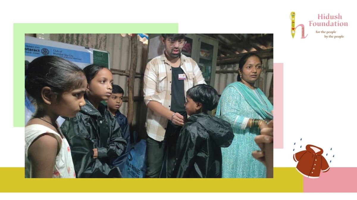 A raincoat being handed to a child