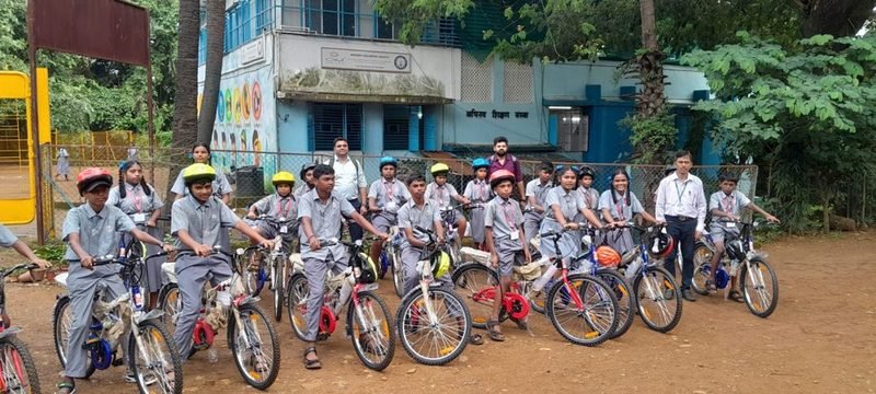 Students with their new bicycles and helmets at Abhinav Vidya Mandir